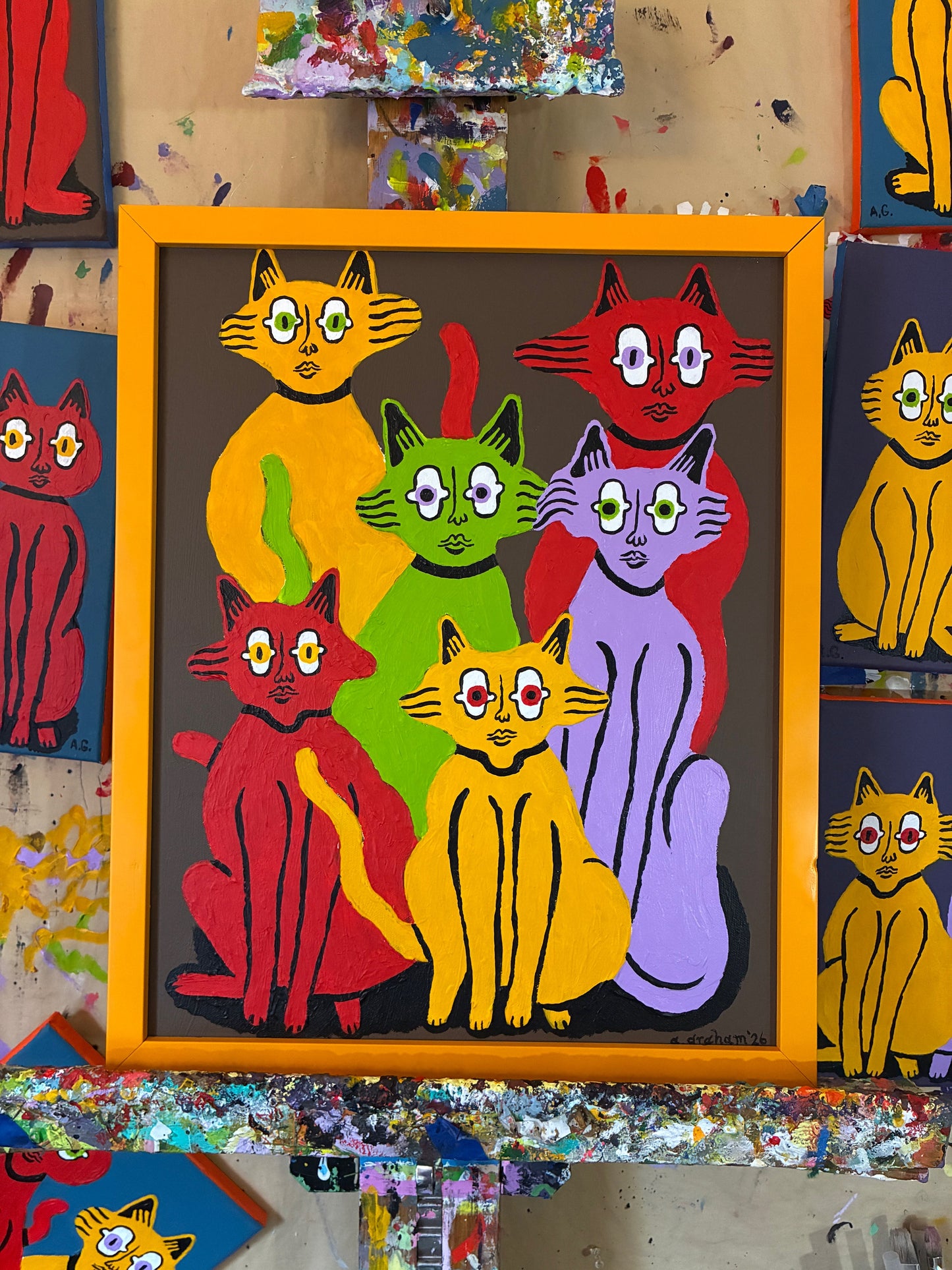 6 cats on brown. Framed